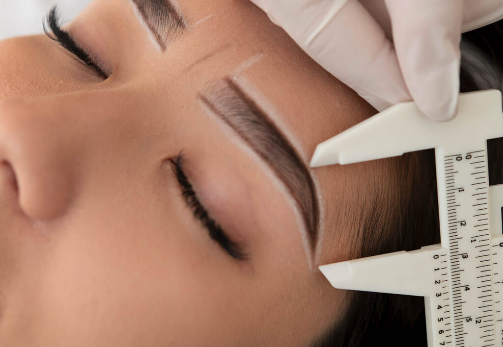 beautician working on a client's eyebrows