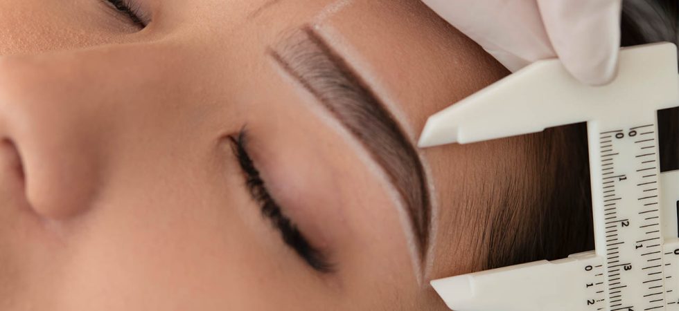 beautician working on a client's eyebrows