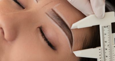 beautician working on a client's eyebrows